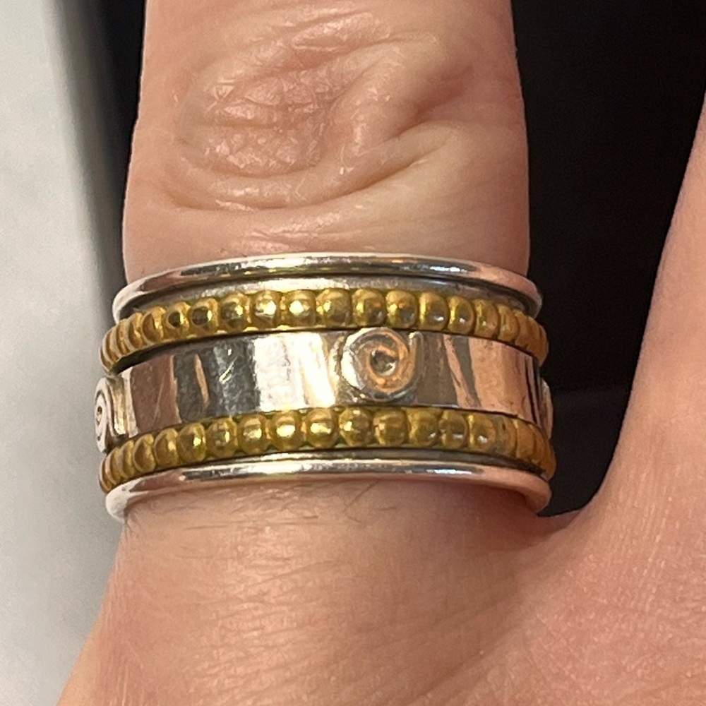 Sterling silver spinner ring. Stamped. Gold accents. 
Size 7.